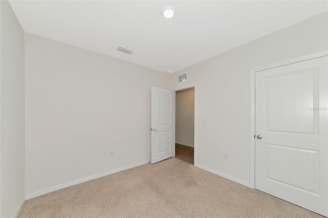 unfurnished bedroom featuring light colored carpet