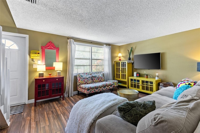 living room featuring a textured ceiling and dark hardwood / wood-style flooring