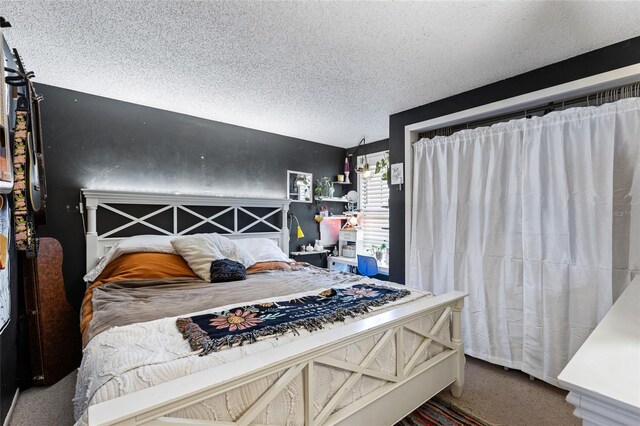 carpeted bedroom featuring a textured ceiling