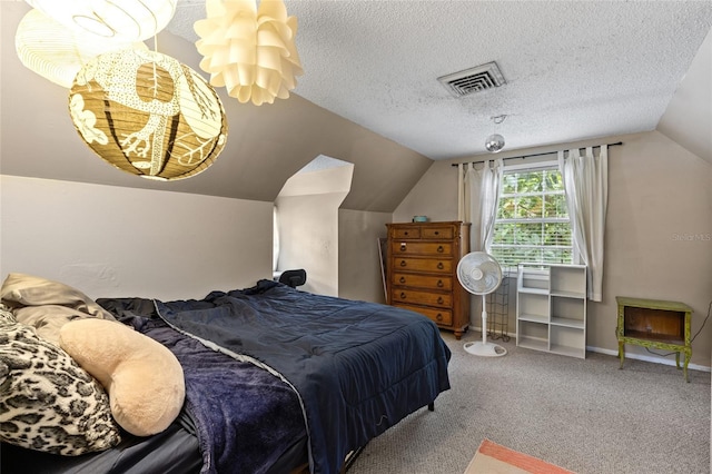 carpeted bedroom with a textured ceiling and lofted ceiling