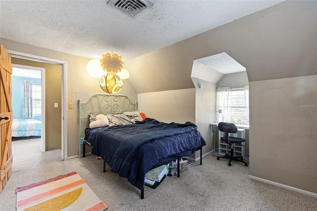 bedroom with carpet floors, a textured ceiling, and vaulted ceiling