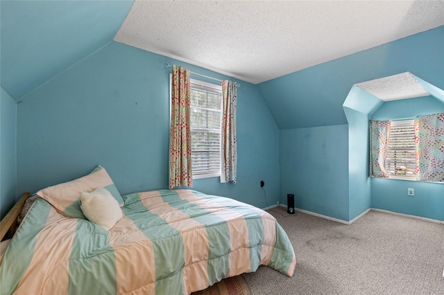 bedroom with carpet floors, a textured ceiling, and lofted ceiling