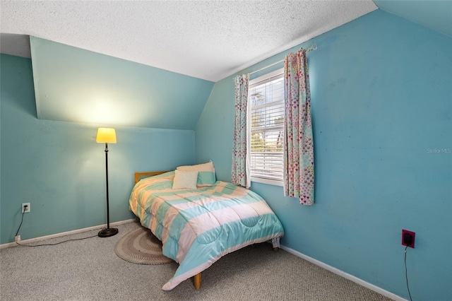 carpeted bedroom featuring a textured ceiling and vaulted ceiling