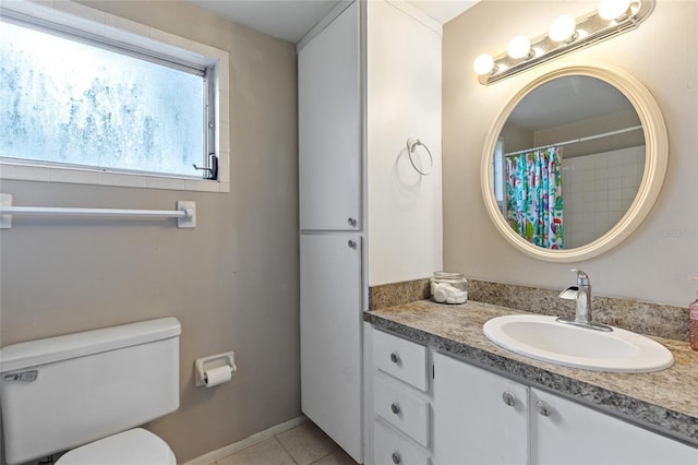 bathroom with vanity, tile patterned flooring, and toilet