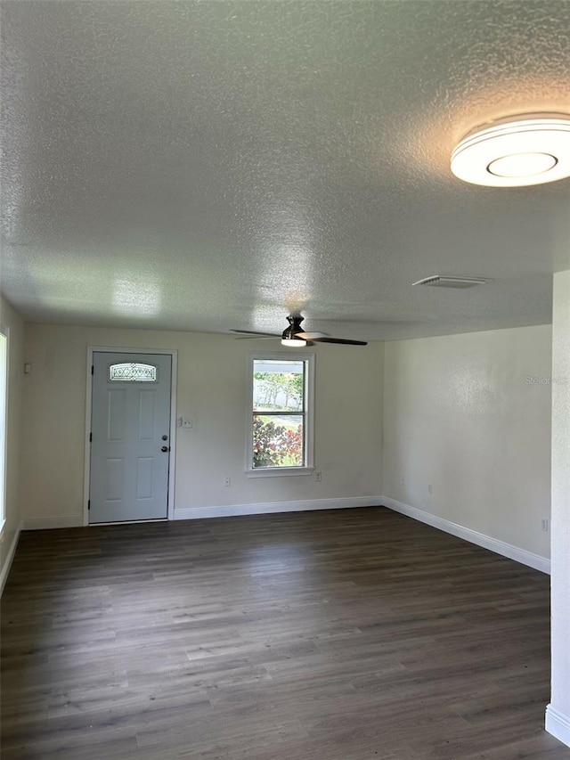 entryway with ceiling fan, a textured ceiling, and dark hardwood / wood-style floors