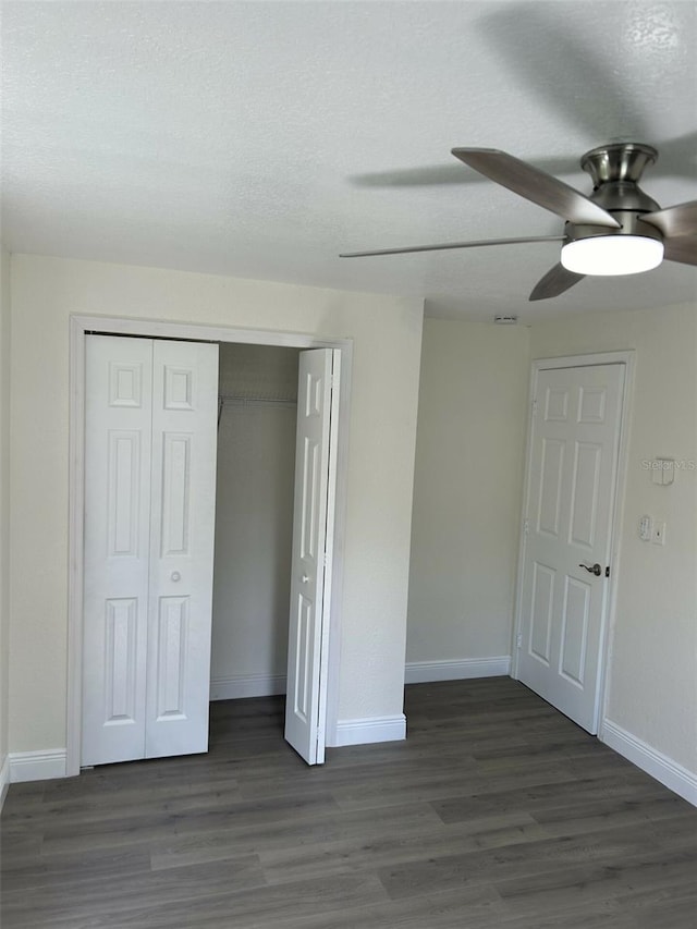 unfurnished bedroom featuring a textured ceiling, ceiling fan, and dark hardwood / wood-style flooring