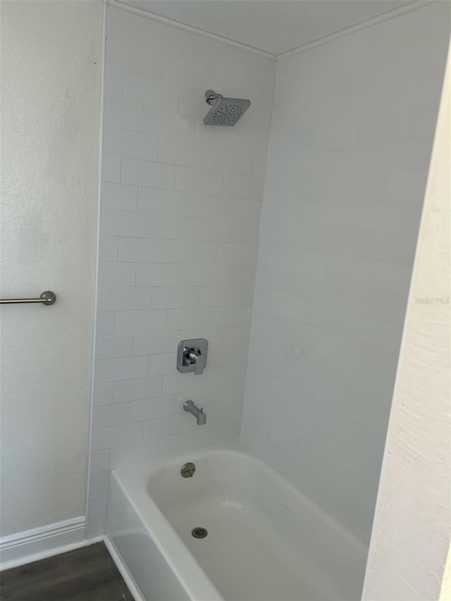 bathroom featuring tiled shower / bath combo and hardwood / wood-style floors