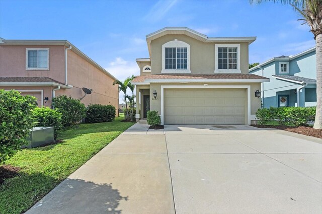 front facade with a garage and a front yard