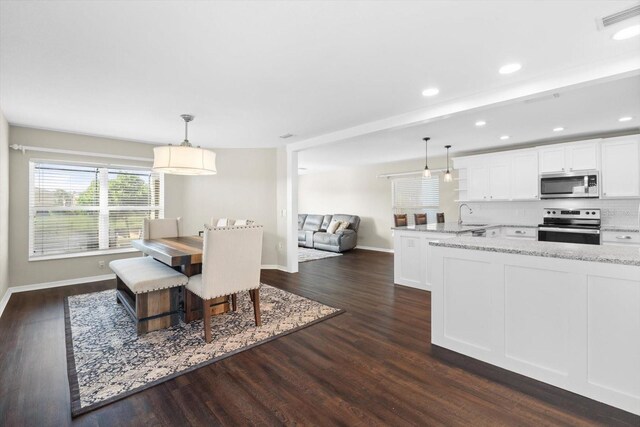 dining room with dark wood-type flooring and sink