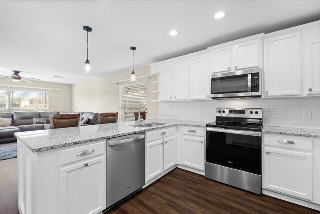 kitchen featuring ceiling fan, sink, kitchen peninsula, white cabinetry, and stainless steel appliances