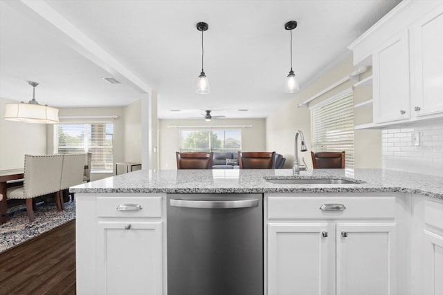 kitchen with dark wood-type flooring, white cabinets, dishwasher, sink, and plenty of natural light