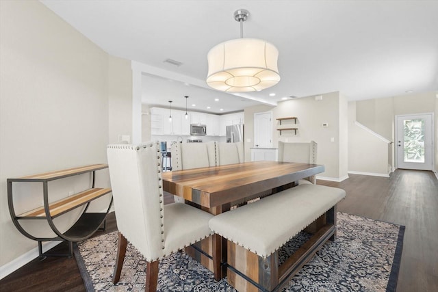 dining room with dark hardwood / wood-style flooring