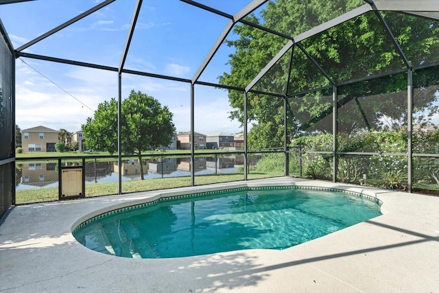 view of swimming pool with a lanai, a patio, and a water view