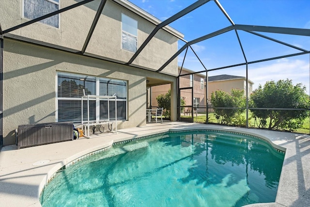 view of pool with a patio and glass enclosure