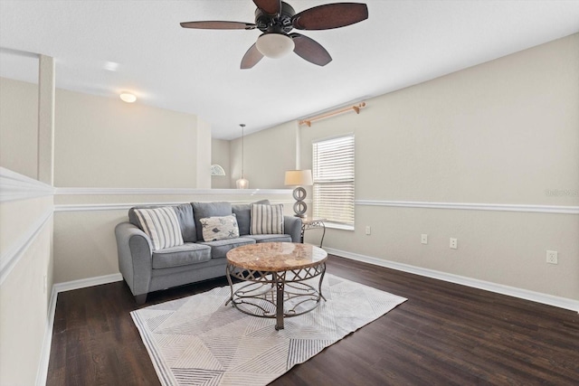 living room featuring dark wood-type flooring and ceiling fan