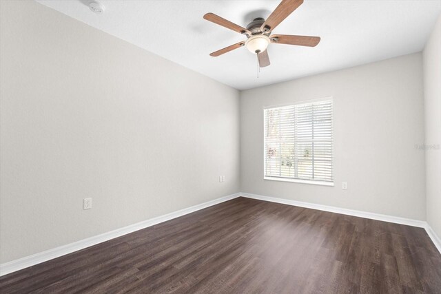 empty room featuring ceiling fan and dark hardwood / wood-style flooring