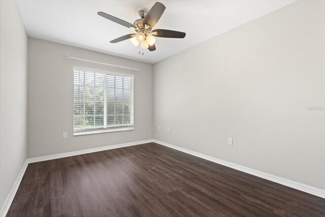 empty room featuring dark hardwood / wood-style floors and ceiling fan