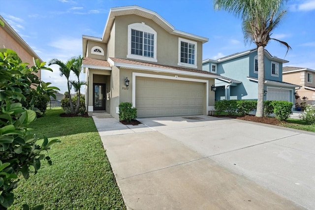 view of front of property with a garage and a front yard