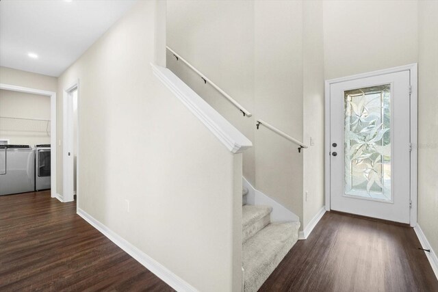 foyer entrance featuring dark hardwood / wood-style floors and independent washer and dryer