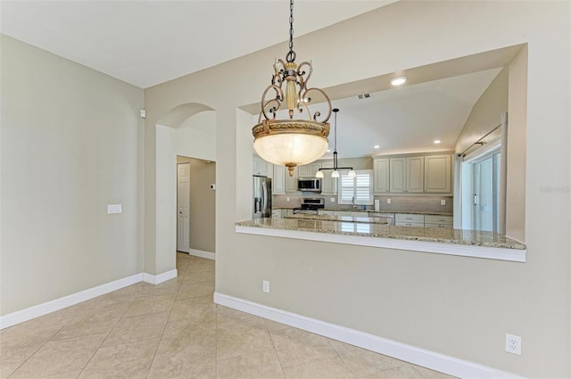 kitchen featuring kitchen peninsula, stainless steel appliances, and hanging light fixtures