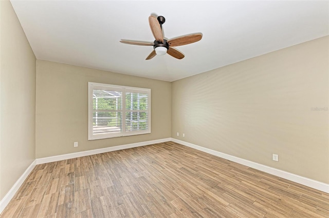 empty room with ceiling fan and light hardwood / wood-style flooring