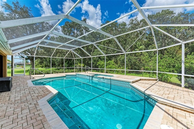 view of pool with glass enclosure, an in ground hot tub, and a patio area