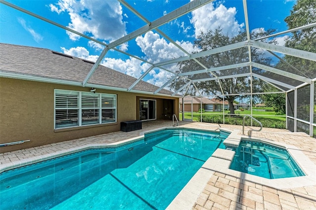 view of swimming pool featuring a patio area, a lanai, and an in ground hot tub