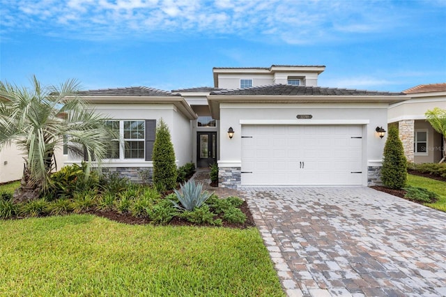 view of front facade featuring a front yard and a garage