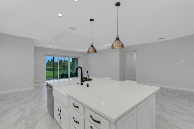 kitchen featuring sink, dishwasher, pendant lighting, white cabinets, and a center island with sink