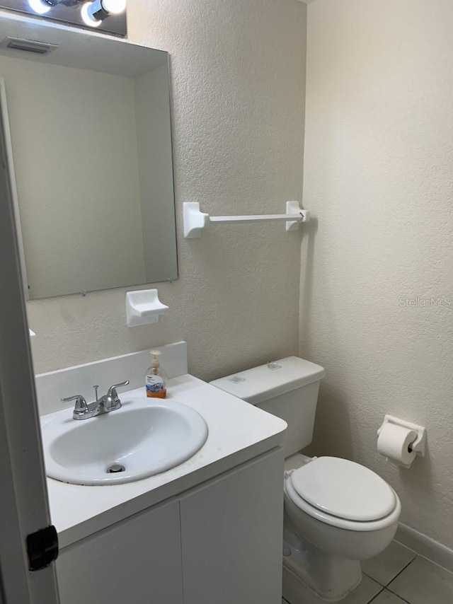 bathroom featuring vanity, toilet, and tile patterned floors