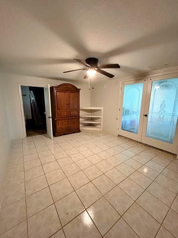 interior space with ceiling fan and light tile patterned flooring