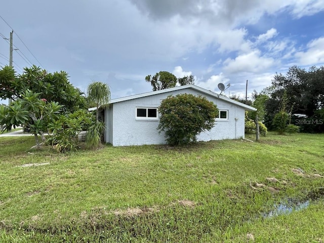 view of property exterior with a yard