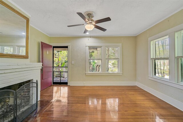 1677 4th St, Sarasota, FL 34236 - living room featuring baseboards, a wealth of natural light, wood finished floors, and a textured ceiling