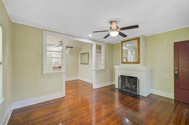1677 4th St, Sarasota, FL 34236 - unfurnished living room featuring baseboards, ornamental molding, a ceiling fan, a fireplace, and hardwood / wood-style floors