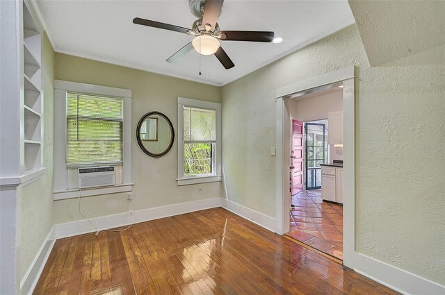 1677 4th St, Sarasota, FL 34236 - spare room with a healthy amount of sunlight, a textured wall, wood-type flooring, and a ceiling fan