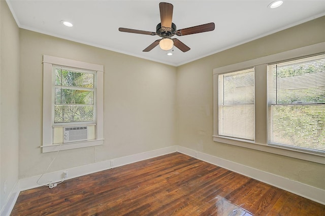 spare room featuring cooling unit, dark hardwood / wood-style floors, ceiling fan, and a wealth of natural light