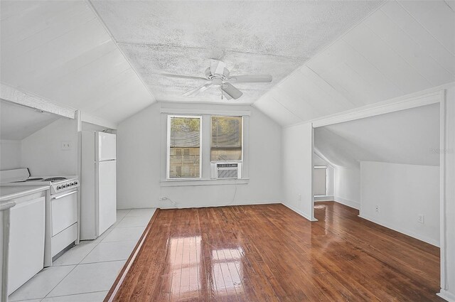 1677 4th St, Sarasota, FL 34236 - additional living space with light wood-style flooring, a textured ceiling, vaulted ceiling, and ceiling fan