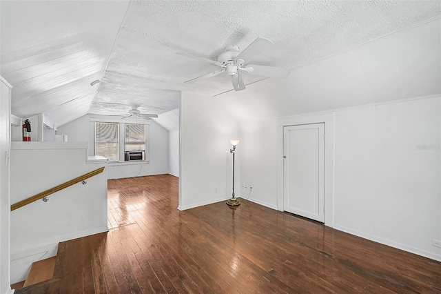 additional living space featuring lofted ceiling, ceiling fan, dark hardwood / wood-style floors, and a textured ceiling