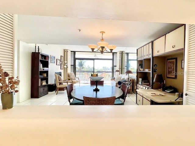 tiled dining room featuring a chandelier