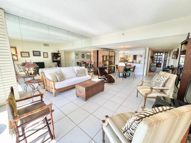 living room featuring light tile patterned floors, visible vents, and a textured ceiling