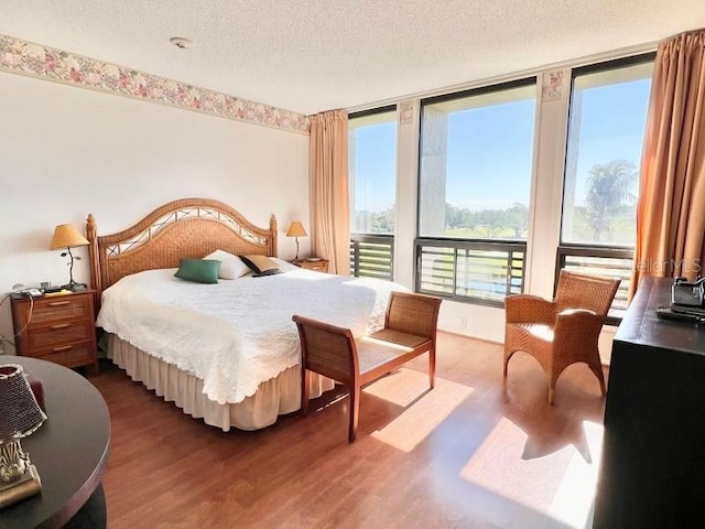 bedroom featuring a textured ceiling and wood finished floors