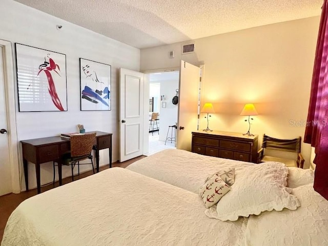 bedroom with a textured ceiling and hardwood / wood-style floors