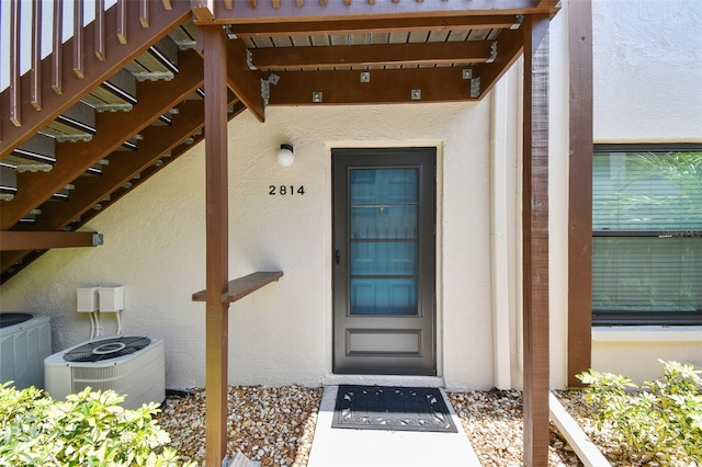 entrance to property featuring central air condition unit