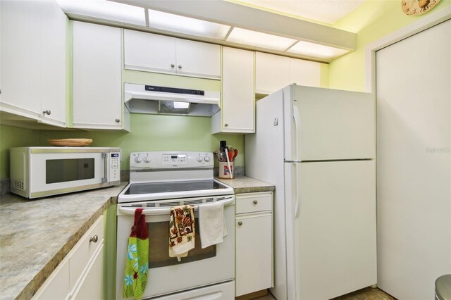 kitchen with white appliances and white cabinetry