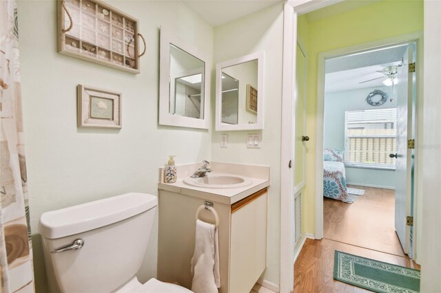 bathroom featuring vanity, toilet, ceiling fan, and hardwood / wood-style flooring