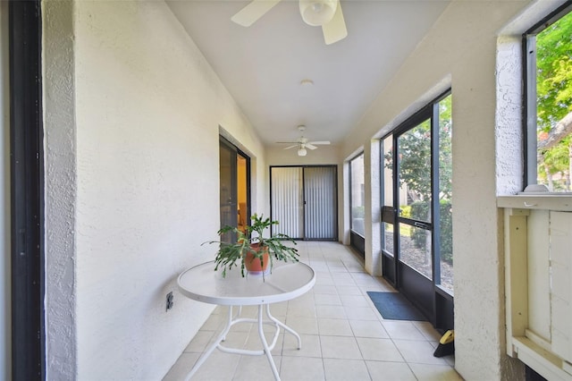 sunroom featuring ceiling fan