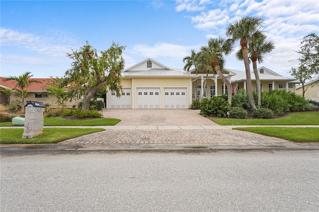 single story home featuring a garage and a front lawn