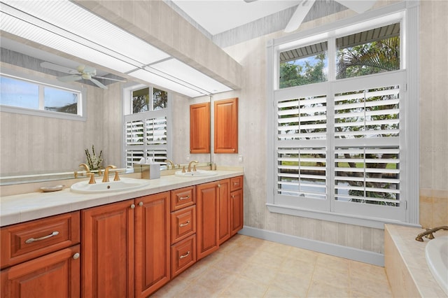 bathroom featuring vanity, ceiling fan, and tiled bath