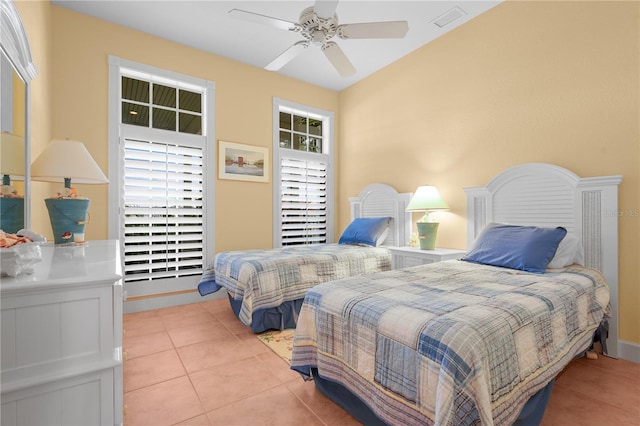 bedroom with ceiling fan and light tile patterned floors