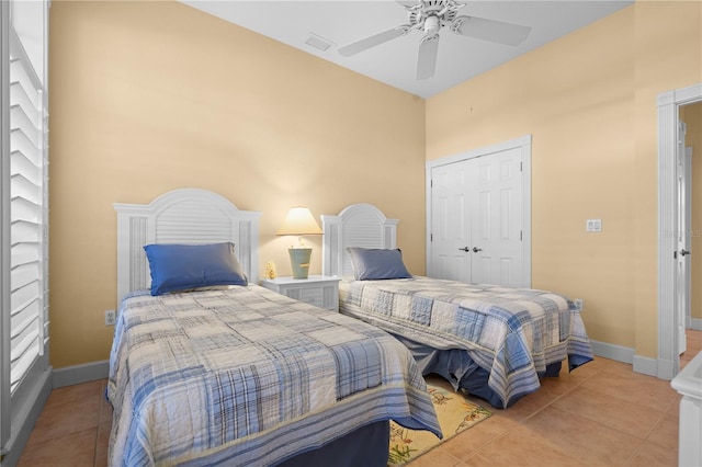 bedroom with a closet, ceiling fan, and light tile patterned flooring